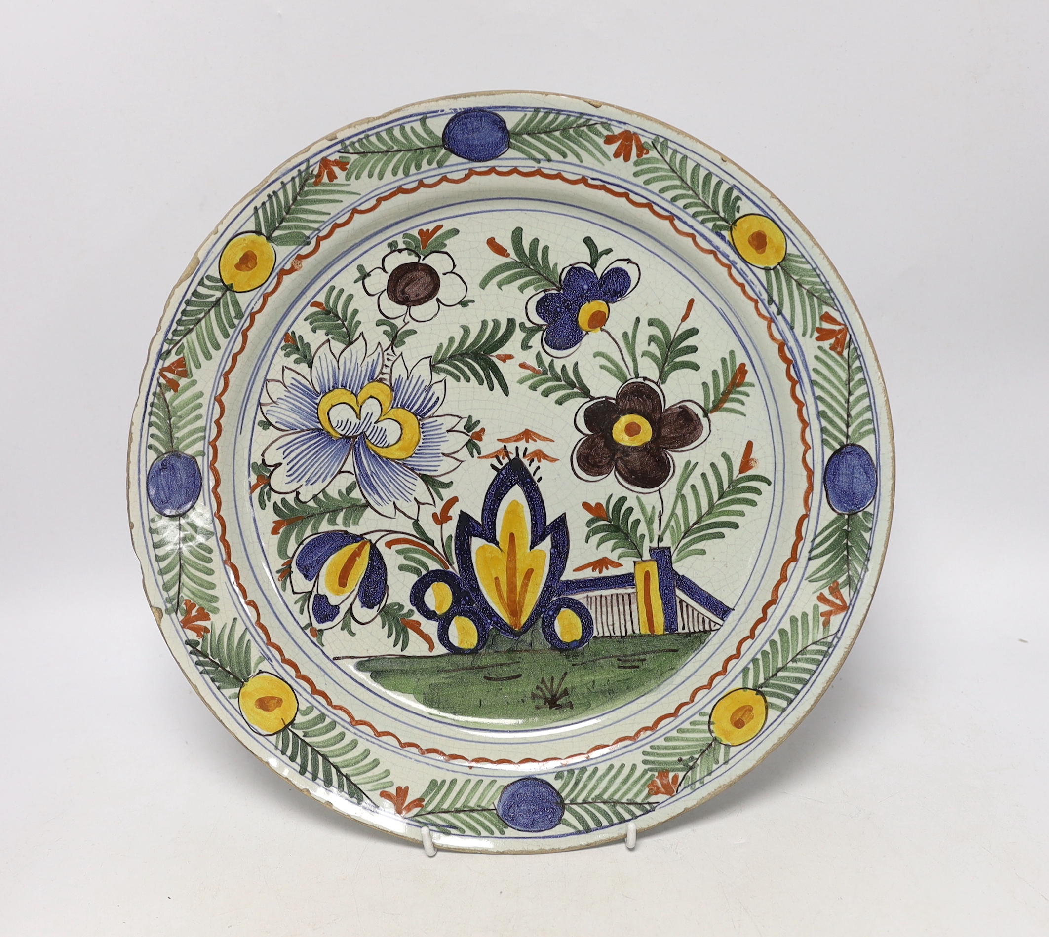 An 18th century Delft polychrome charger, 34cm